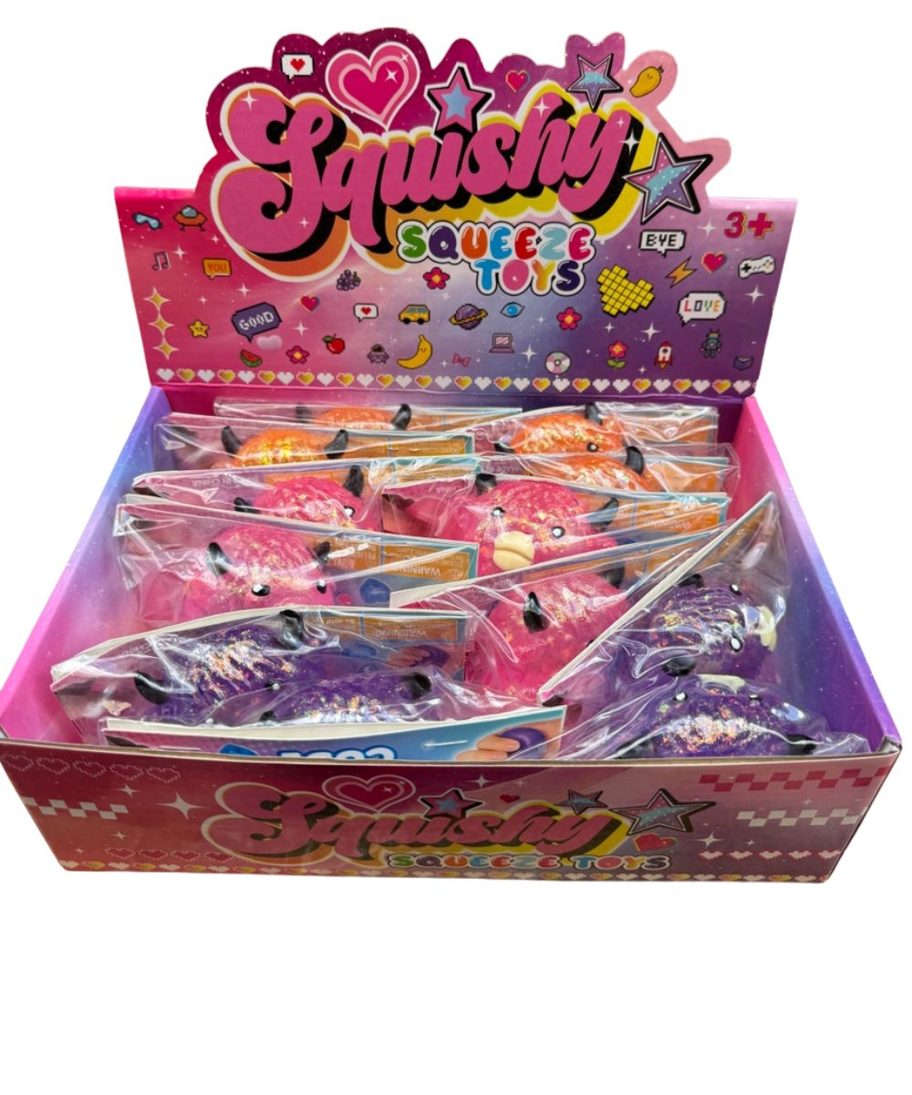 pink display of small glitter highland cows of orange, pink, and purple in clear plastic packaging