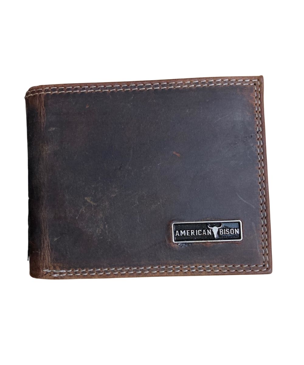 Front view of the men's brown American Bison leather bifold wallet featuring the silver logo plate on the front