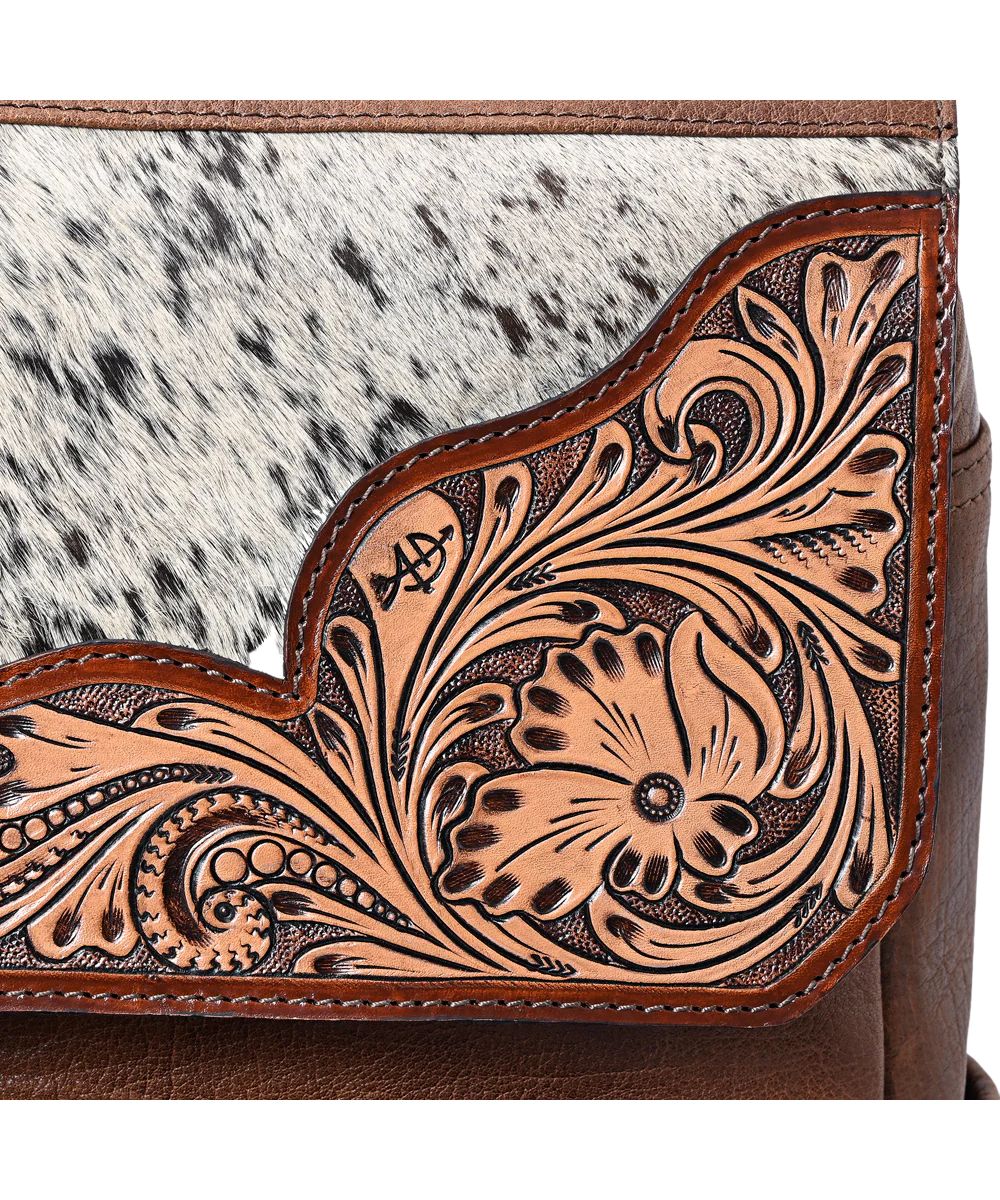 Close up view of the floral tooled and hair-on-hide accents.