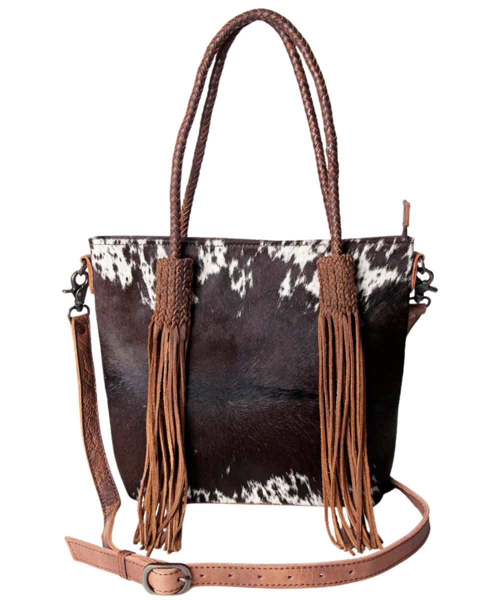 Black and white hair-on cowhide leather front featuring braided leather straps and long fringe tassels.