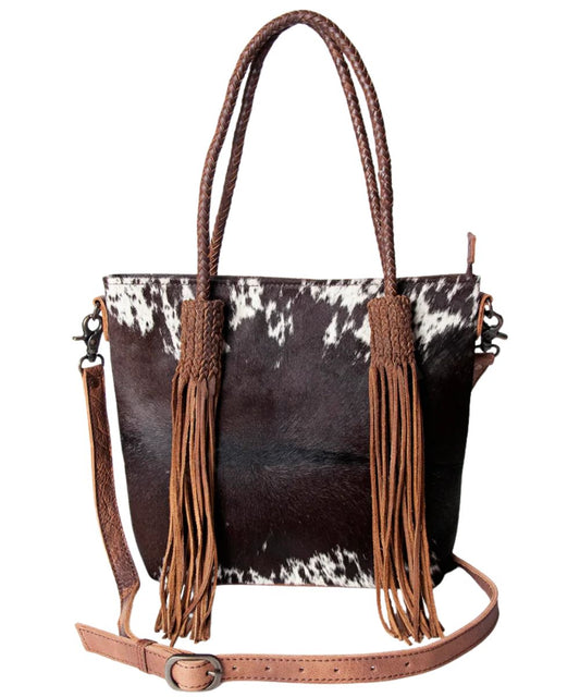 Black and white hair-on cowhide leather front featuring braided leather straps and long fringe tassels.