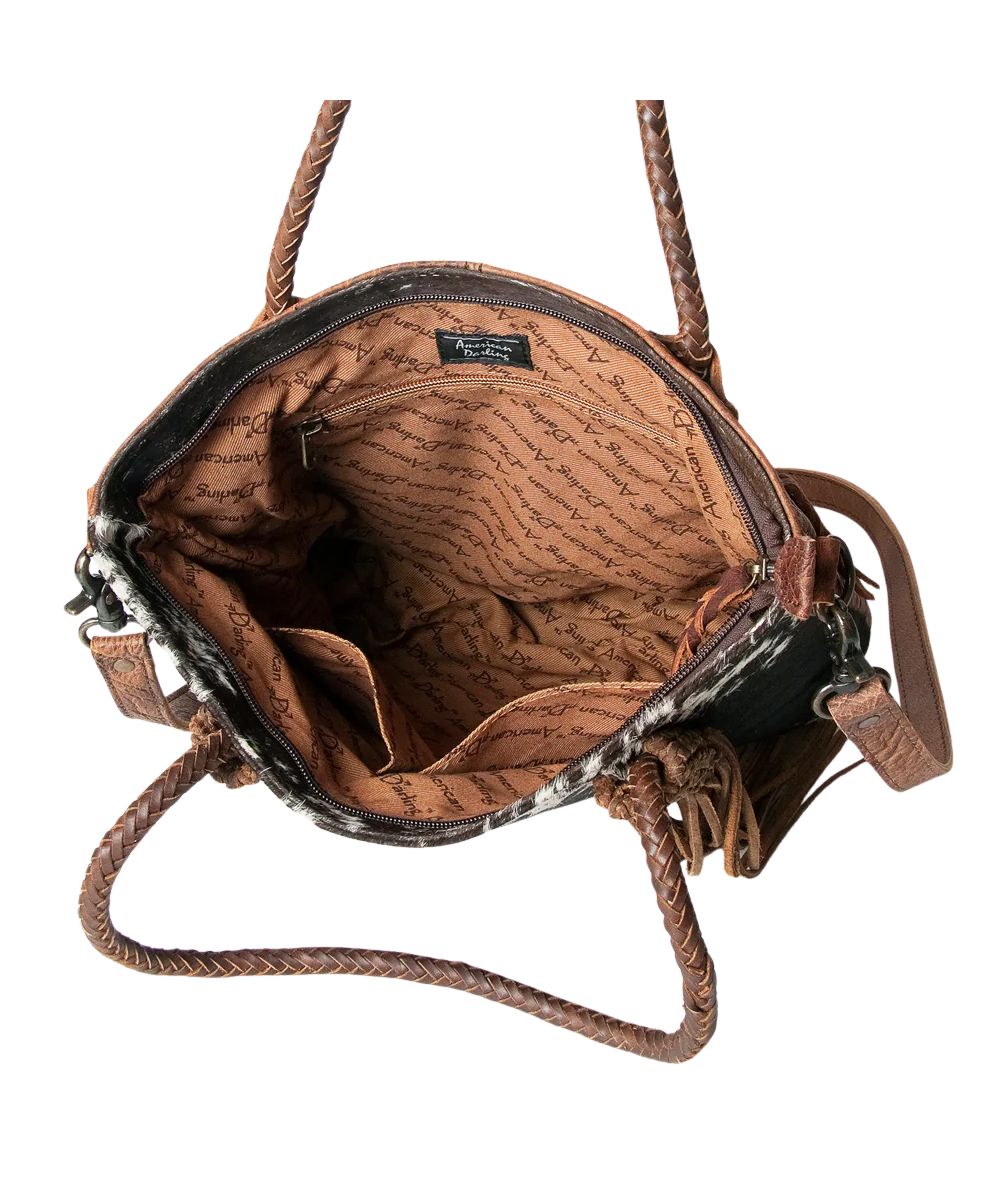 Spacious interior contains a zippered pocket and two open pockets in this genuine leather tote bag by American Darling.