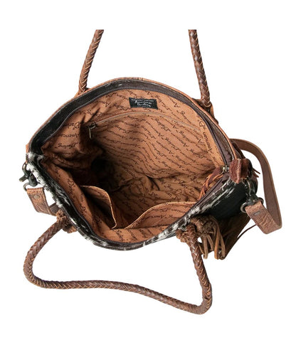 Spacious interior contains a zippered pocket and two open pockets in this genuine leather tote bag by American Darling.