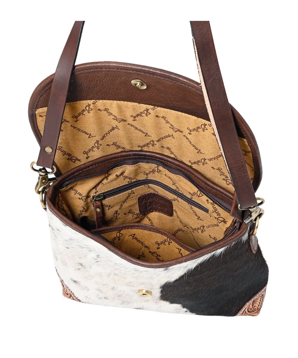 Spacious interior contains a zippered pocket and an open pocket. This messenger bag comes complete with removable/adjustable shoulder strap.