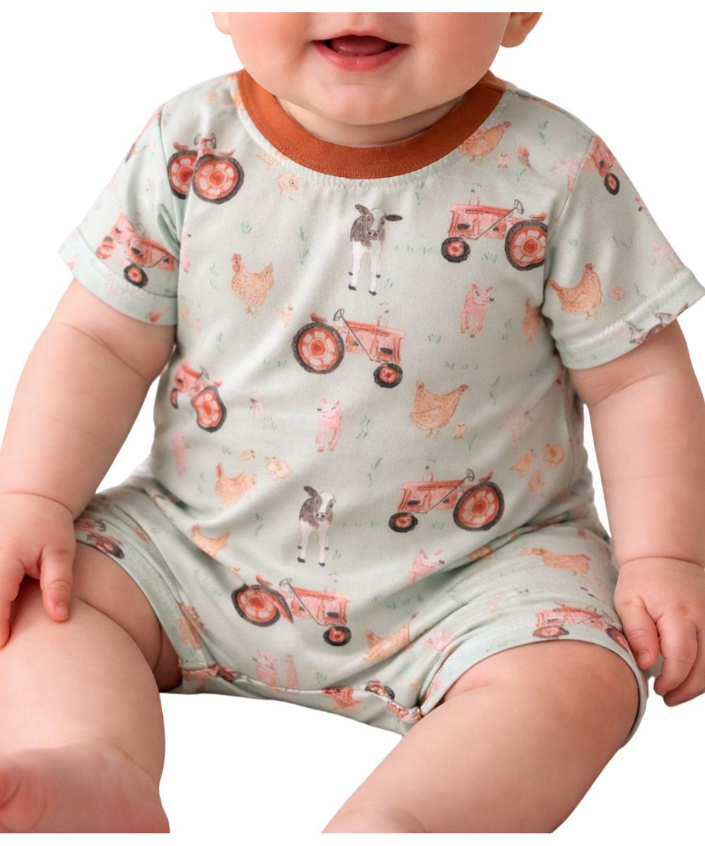 Baby romper with a soft sage green base featuring a farm animal and tractor print finished with a contrasting rust-colored collar.