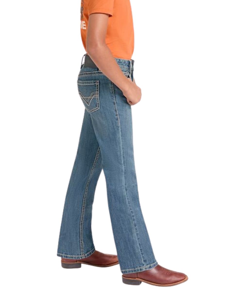 Side view of the boy's medium wash boot cut jean
