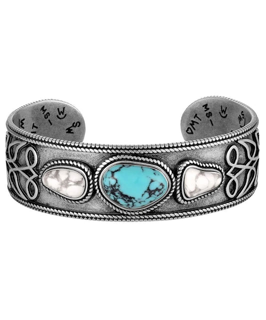 Side view of the women's silver cuff bracelet featuring the crafted turquoise and crafted howlite stones
