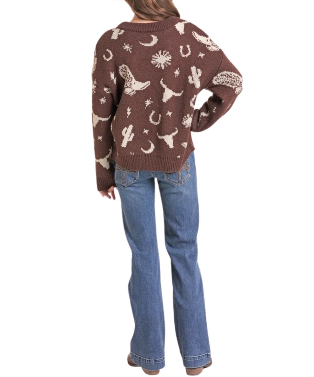 Back view of the girl's chocolate brown long sleeve sweater featuring the dropped shoulders, western print in white, and rib knit trim