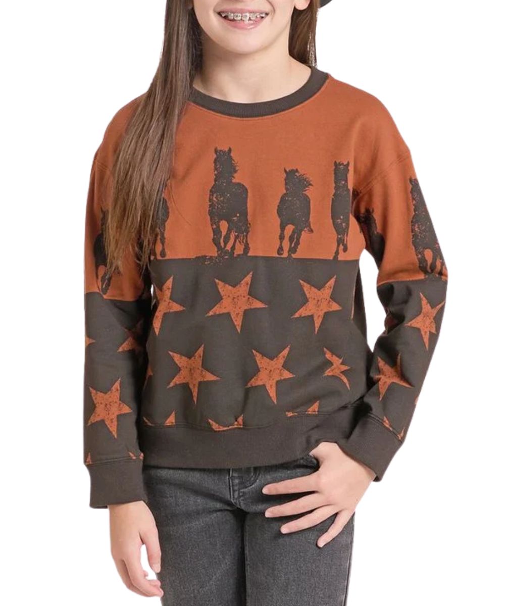 Front view of the girl's rust Rock & Roll Cowgirl long sleeve sweatshirt featuring the color blocked design with a rust upper body and black lower body, the top features a contrast horse print and the lower features a contrast star print