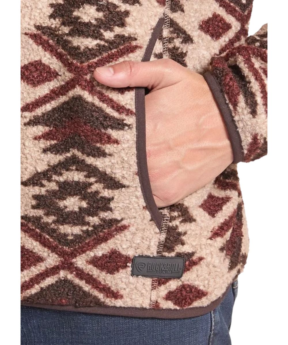 Close-up view of the aztec print, kangaroo pocket, and logo label at the hem