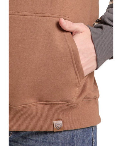 Close-up view of the tan kangaroo pocket on the men's camo color blocked hoodie