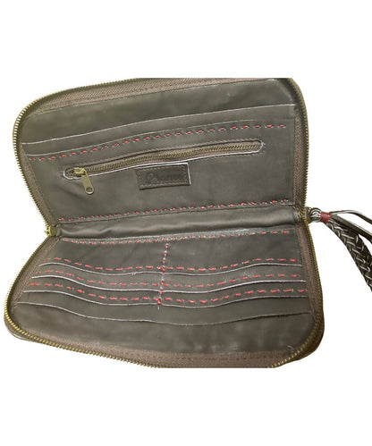 An open zip-around wristlet wallet in brown leather, showing multiple interior card slots, a zip pocket, red contrast stitching, and a braided strap