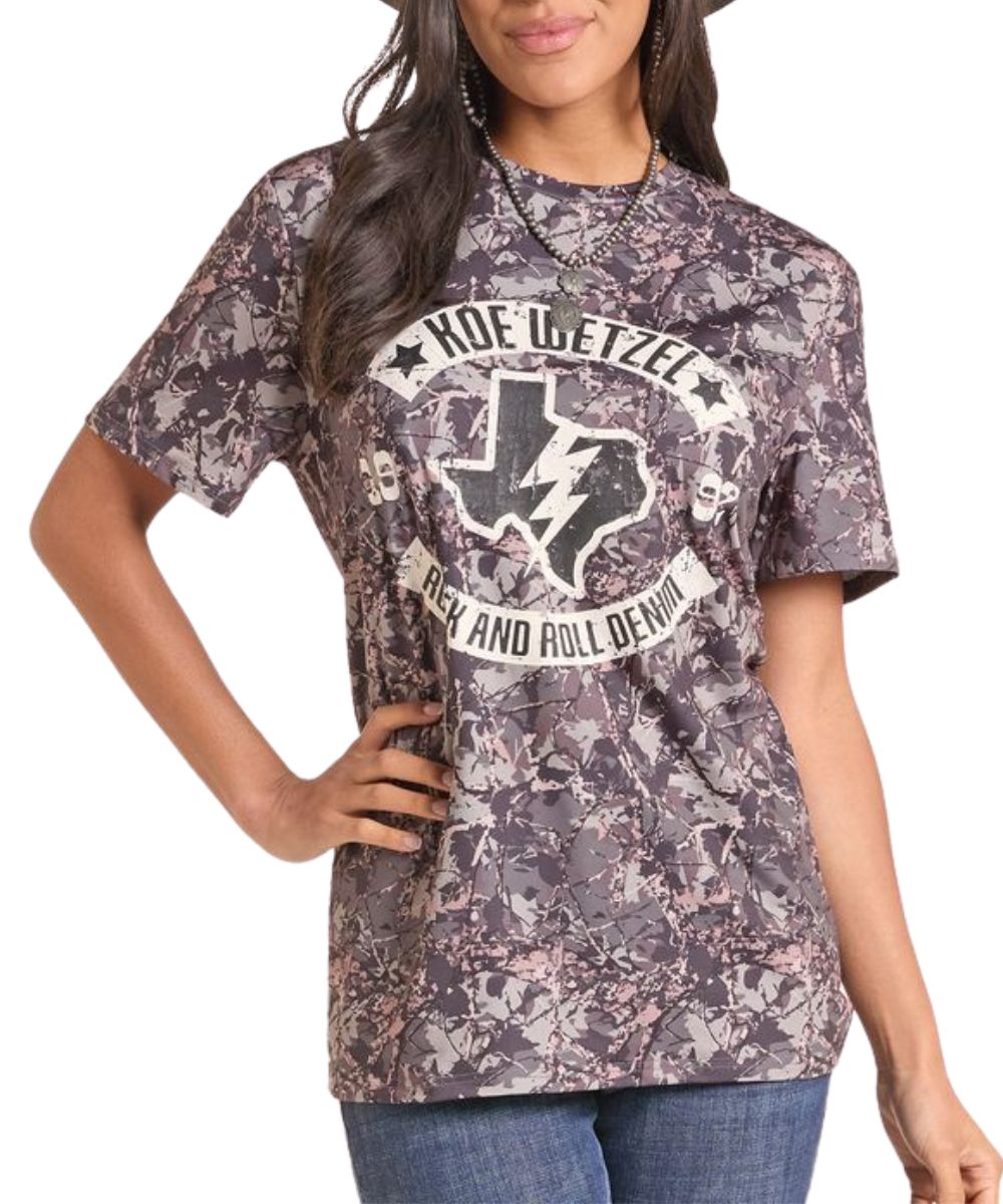 Front view of a woman modeling the camo graphic tee featuring the Koe Wetzel Texas logo screen-printed graphic on the front
