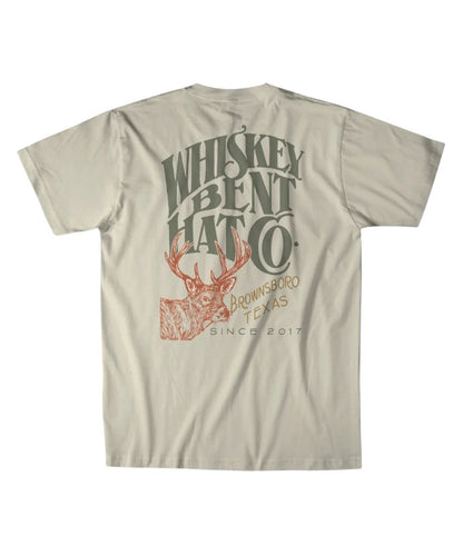 Back view of the men's natural Whiskey Bent Hat Co. short sleeve graphic tee featuring the large screen-printed logo with a buck deer graphic