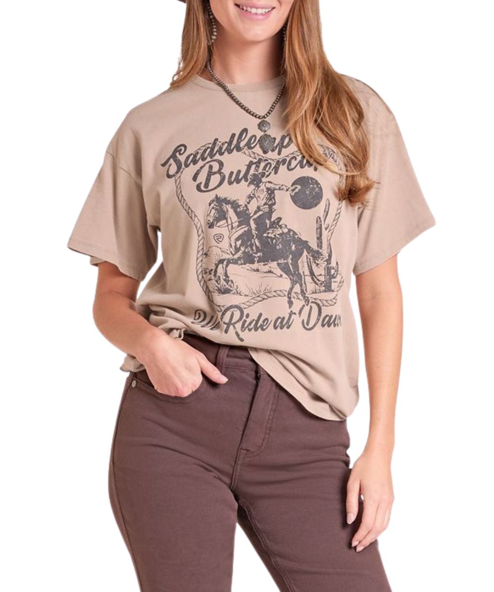 Front view of the women's Rock & Roll Cowgirl taupe oversized graphic tee featuring the front screen-printed desert cowboy graphic that reads: "Saddle Up Buttercup We Ride At Dawn"