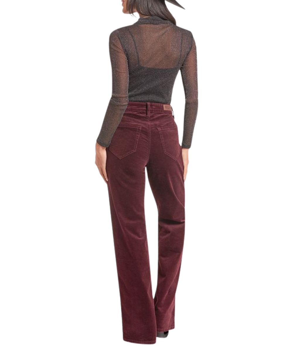 Back view of the women's black sheer long sleeve top featuring the mock neck and metallic accents throughout