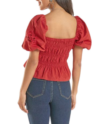 Back view of the women's red short balloon sleeve blouse featuring an elastic gathered body and ruffle cropped hem