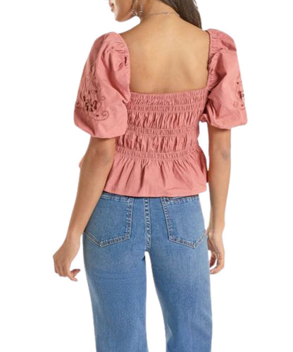 Back view of the women's rose/mauve short balloon sleeve blouse featuring an elastic gathered body and ruffle cropped hem