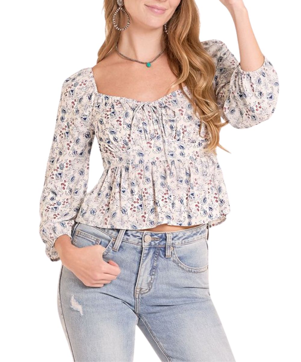 Front view of the women's long puff sleeve floral print blouse in cerulean blue featuring a sweetheart neckline with elastic cuffs and neckline