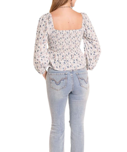 Back view of the women's cerulean floral long sleeve blouse featuring a smocked back and a square back neckline