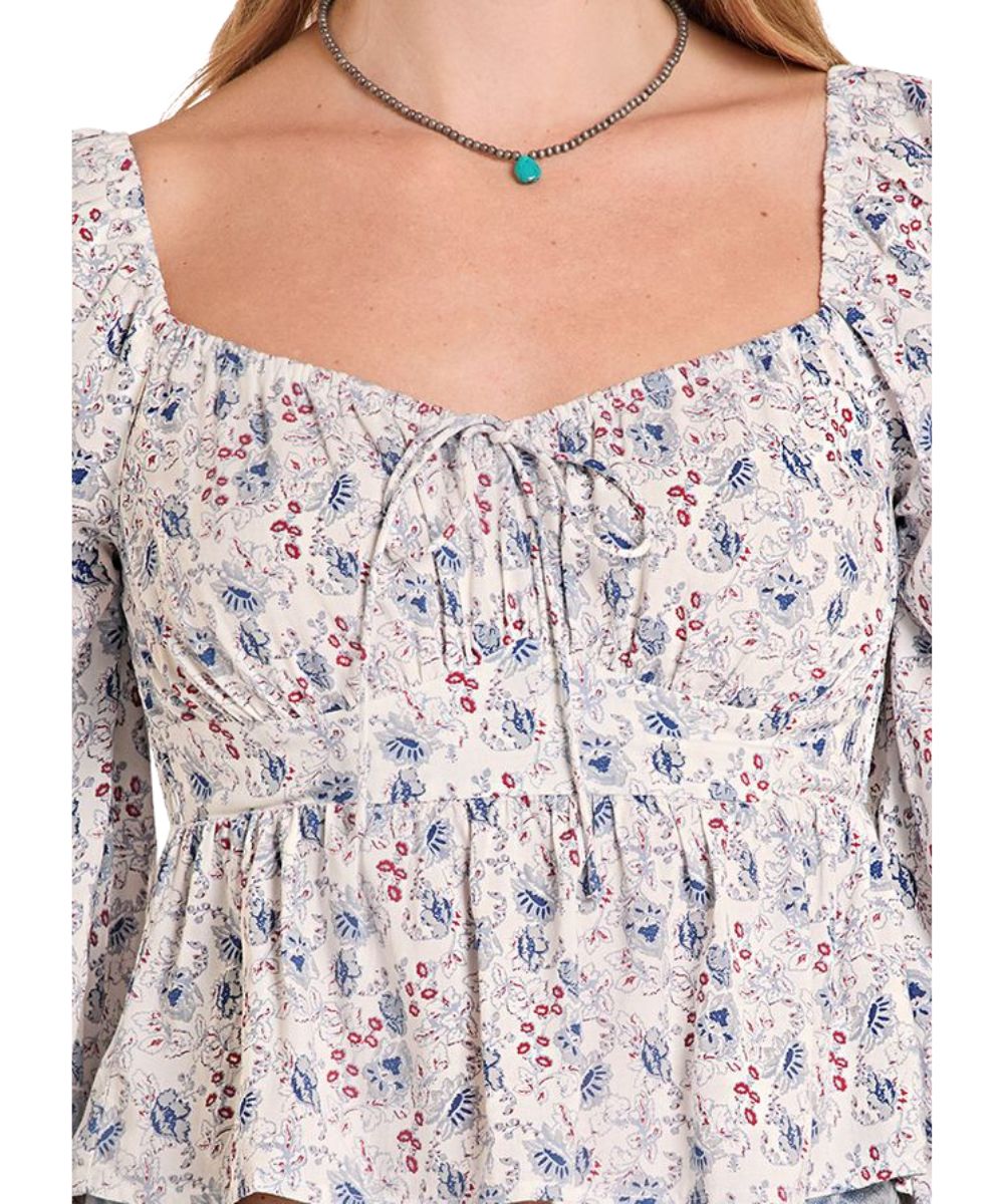 Close-up view of the floral print, self-tie front bow, and elastic trim