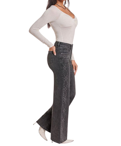 Side view of the women's black wide leg jean featuring the studded side seams