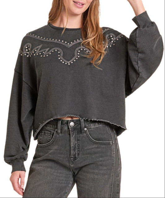 Front view of the women's Rock & Roll Cowgirl long sleeve black cropped sweatshirt with western-style embroidery and stud detailing across the chest