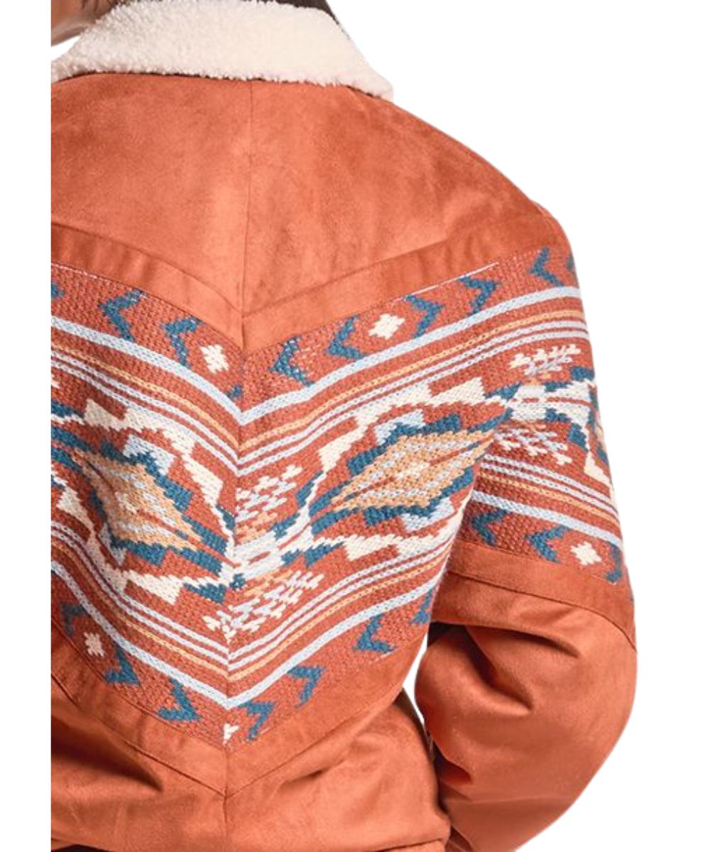 Close-up view of the aztec border print on the women's rust bomber jacket