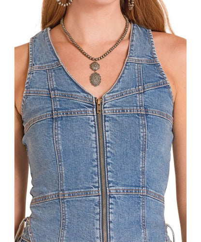 Close-Up Fabric View Of The Women's Zip-Up Denim Vest Featuring A V-Neckline And Seam Detailing