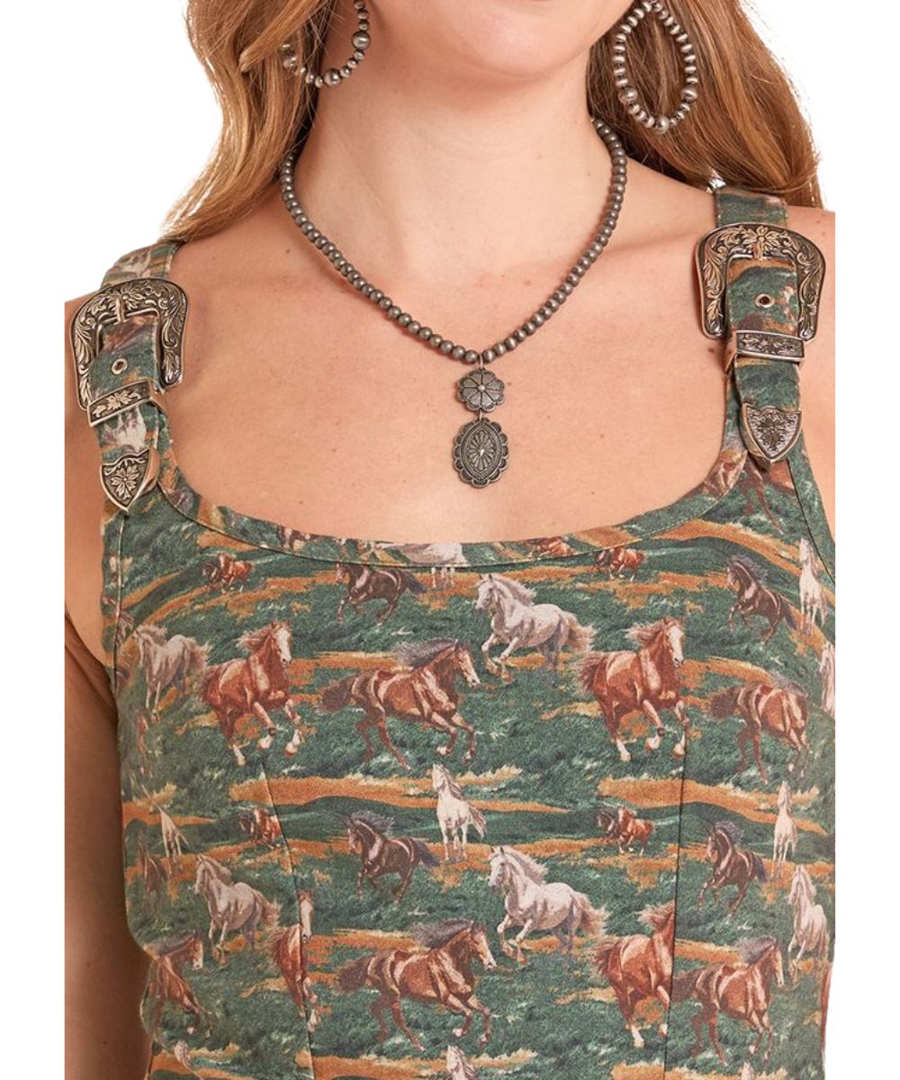 Close-up view of the round neckline, buckle shoulder straps, and the geometric horse print