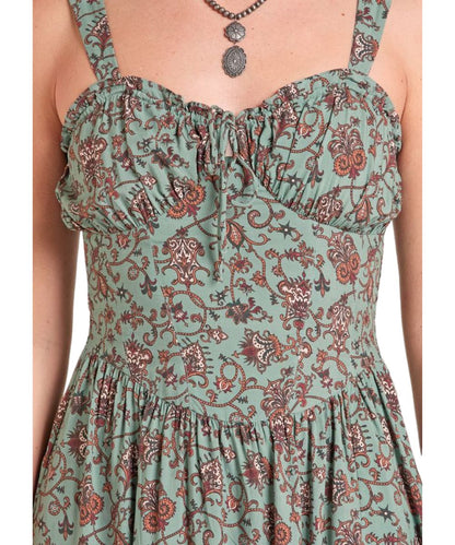 Close-up view of the v-neckline with a self-tie closure, corset bodice, and floral print on the women's hunter green midi length dress