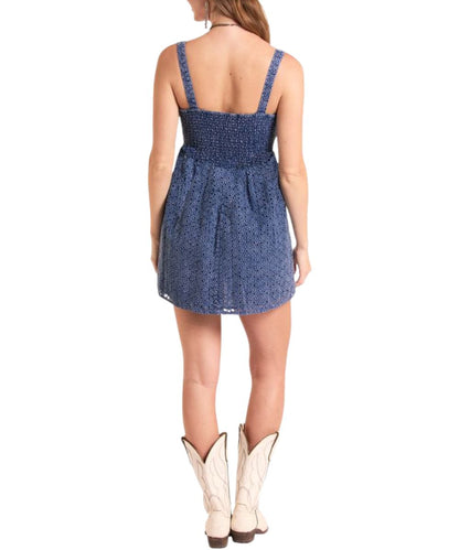 Back view of the women's navy eyelet mini dress featuring a smocked back