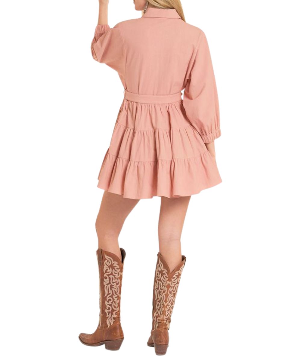 Back view of the women's mini dress in rose/mauve featuring a tiered ruffle skirt