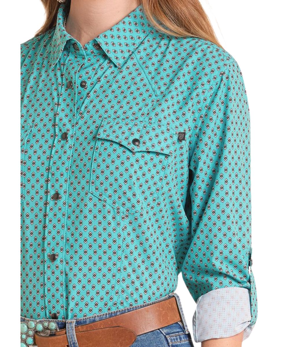 Close-Up View Of The Women's Peacock/Turquoise Snap Shirt Featuring Western Yokes, Chest Pockets, And Moisture Wicking Fabric