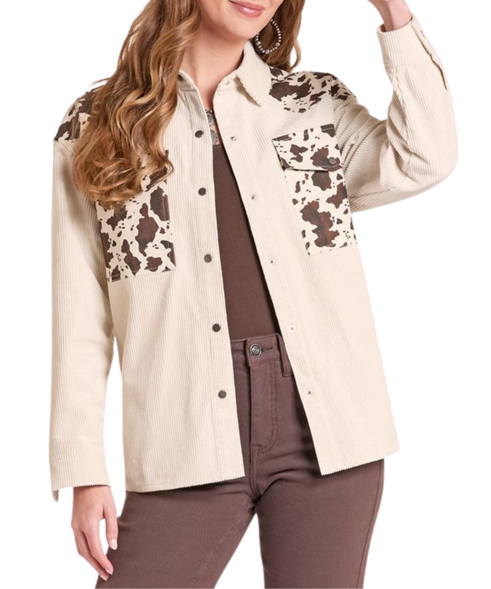 Front view of the women's natural Rock & Roll Cowgirl corduroy shirt jacket featuring the cow print color blocked design on the oversized chest pockets and yokes
