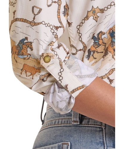 Close-up view of the horse printed women's long sleeve snap shirt featuring the adjustable cuffs with a roll tab to make rolling up your sleeves easy