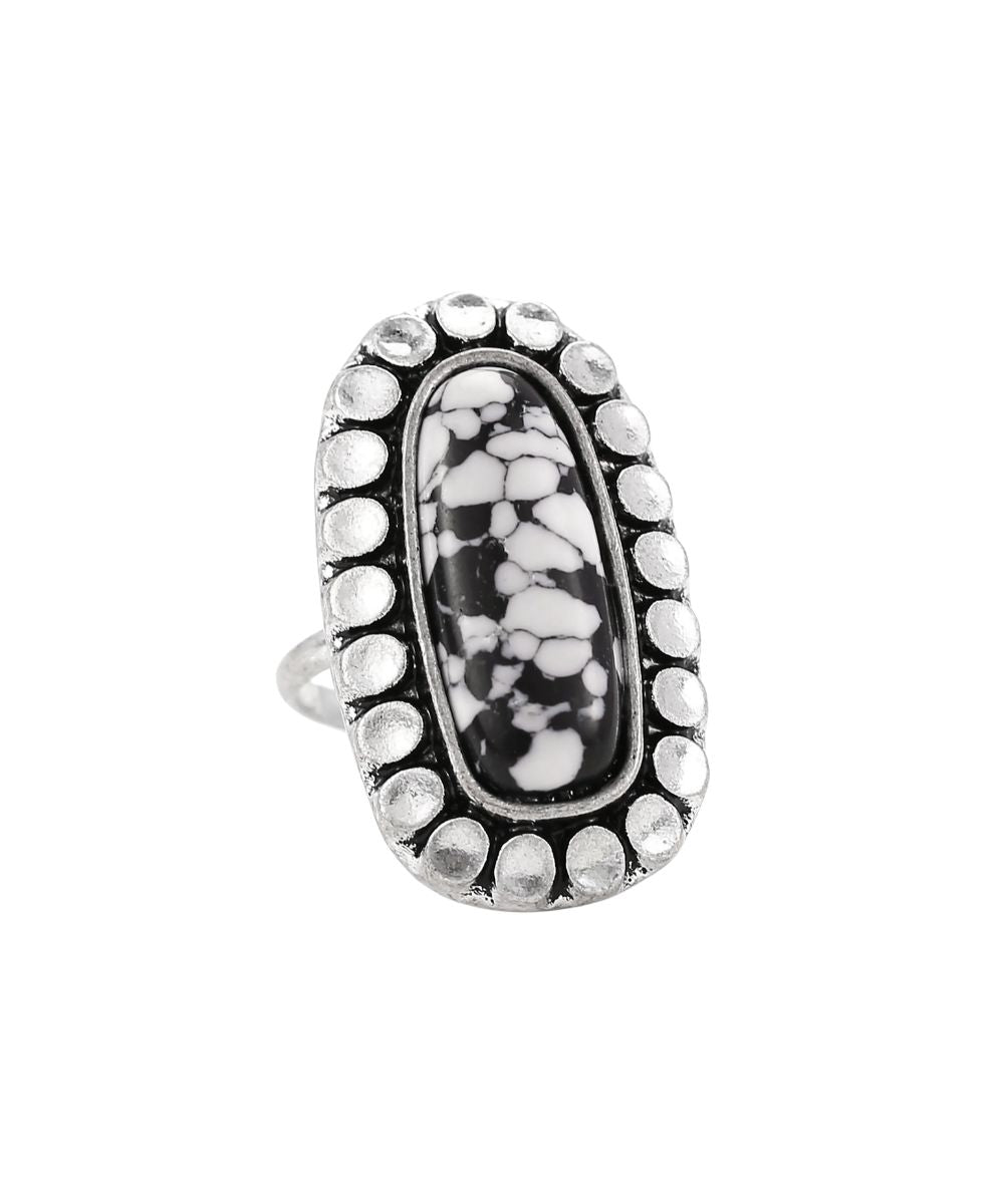 Cowgirl Confetti women's silver ring featuring the long oval black and white zebra jasper center stone with a hammered beaded edge setting, this ring features an adjustable band