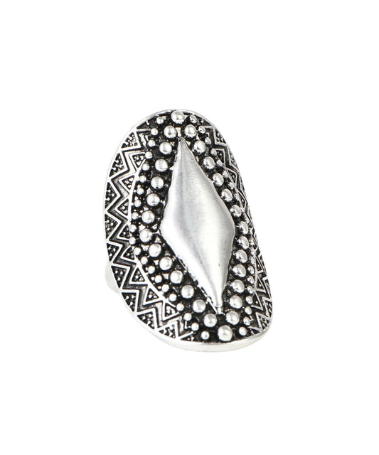 A silver-toned statement ring featuring a large central diamond-shaped inlay surrounded by textured bezel-set round stones, with a geometric patterned border, shown on a plain white background.