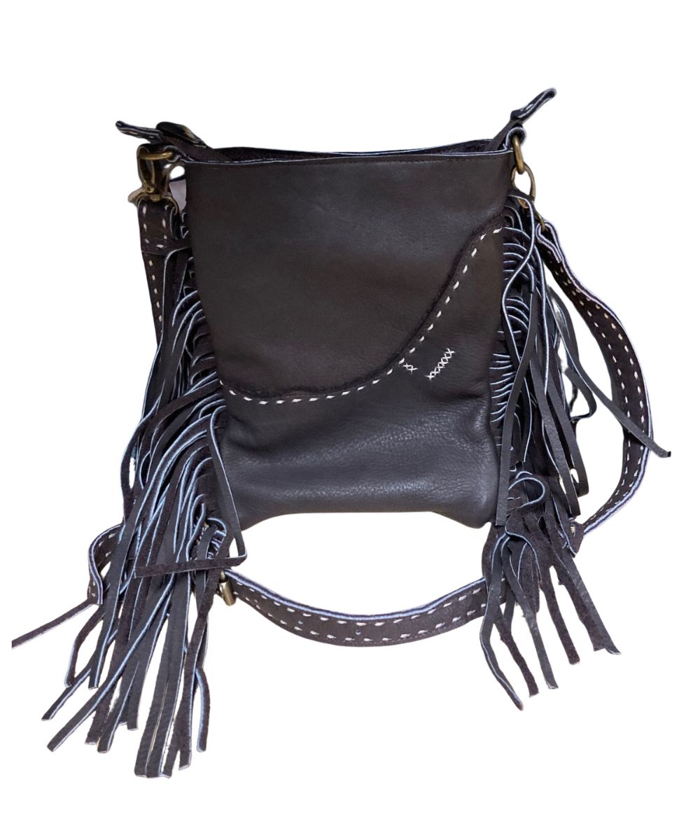 Back view of the women's brown leather crossbody featuring the fringe details, top zip closure, removable/adjustable crossbody strap, and contrast stitched accents
