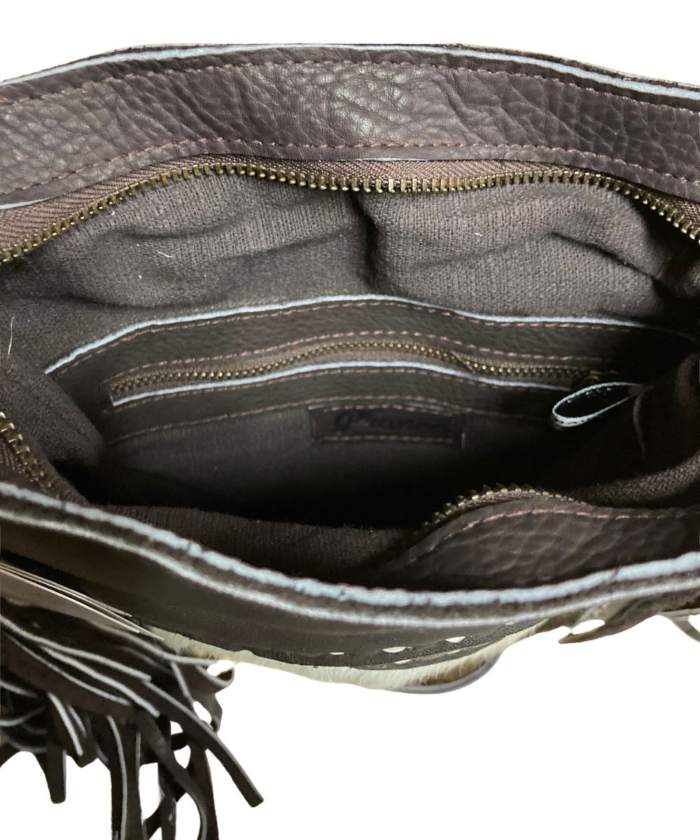 Interior view of the women's brown Pranee bag featuring the 1 interior zip pocket and 1 interior slip pocket