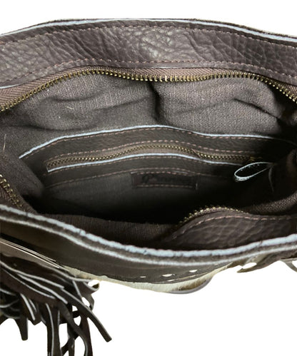 Interior view of the women's brown Pranee bag featuring the 1 interior zip pocket and 1 interior slip pocket