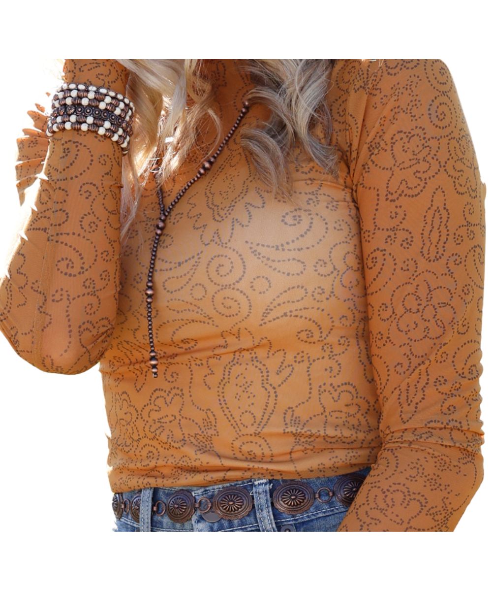 Close-up view of the geometric floral print on the women's gold mesh top