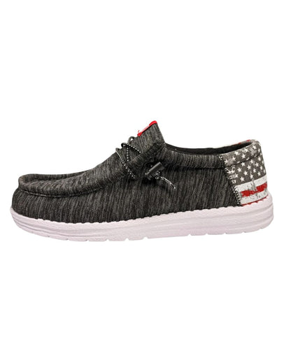 Left side view of the men's casual shoe featuring the pitch black upper, adjustable elastic laces, slip-on entry, and contrast American Flag heel