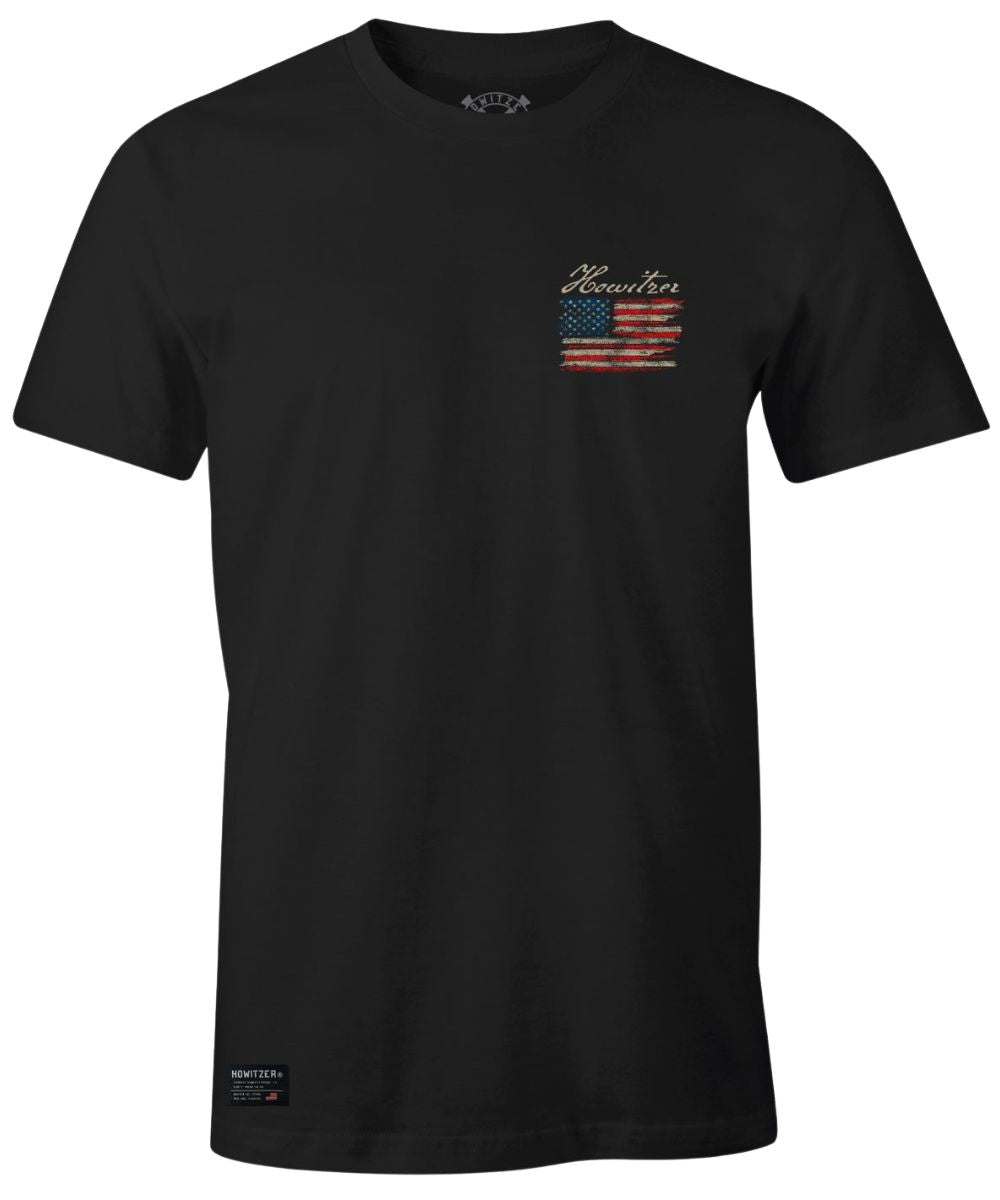 Front view of the men's black graphic tee featuring the small distressed American Flag with logo screen-printed on the upper left chest