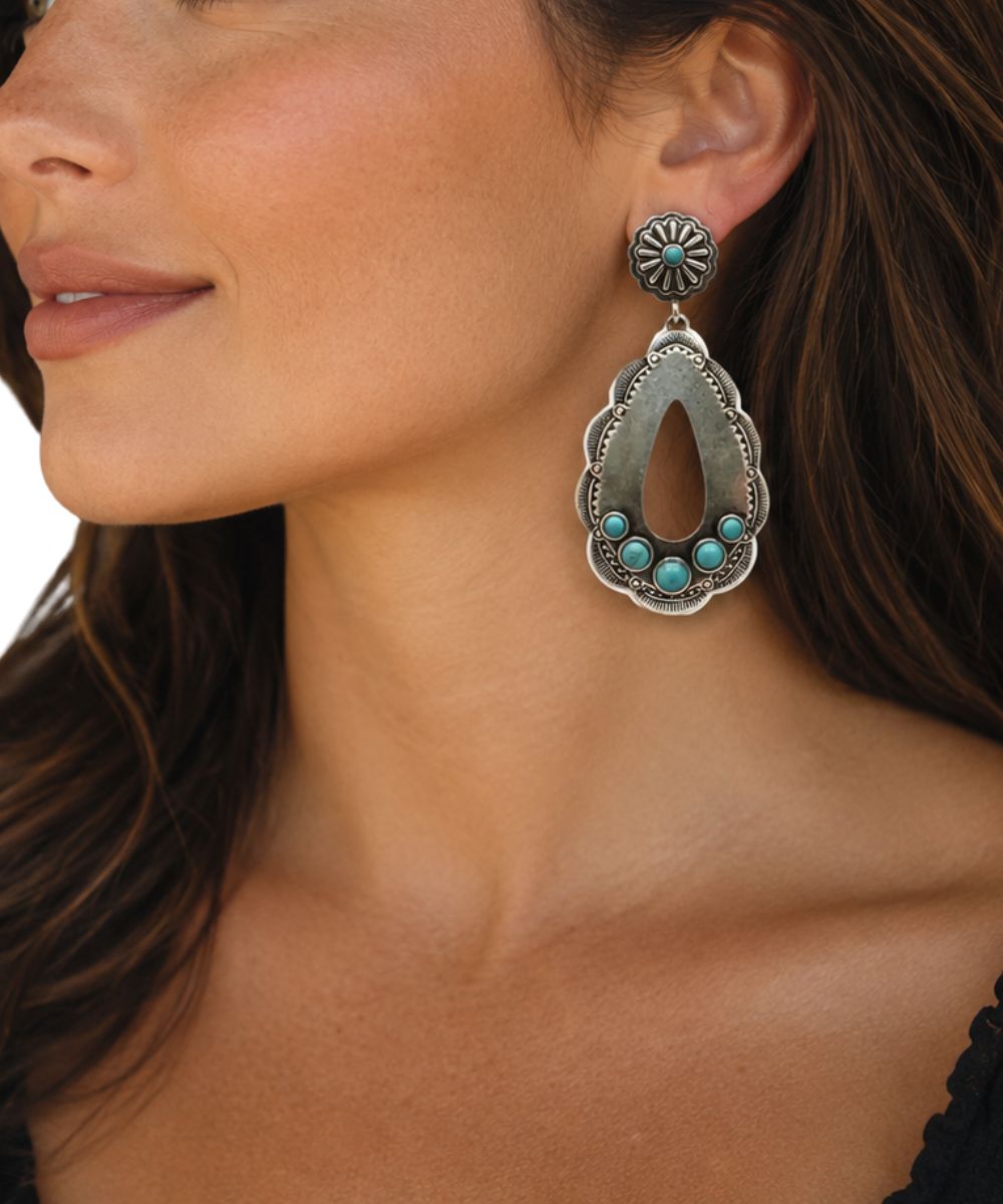 silver dangle earrings with faux turquoise stones on a female model