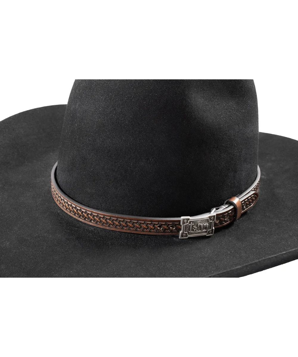 A close-up of a black cowboy hat featuring a brown braided leather band with a silver-toned metal buckle.