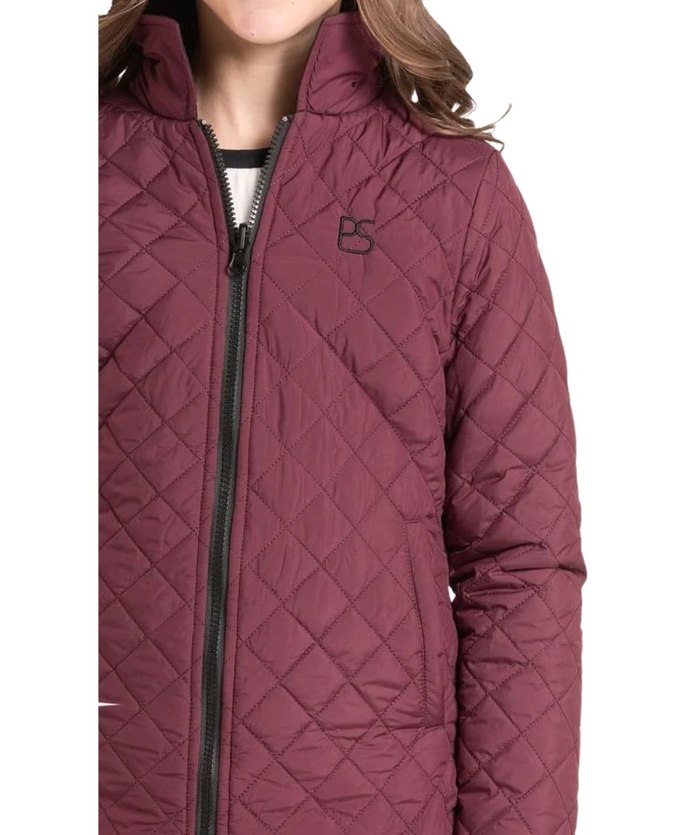 Close-up view of the girl's wine quilted reversible jacket featuring the logo embroidery at the left chest. This wine jacket reverses to black