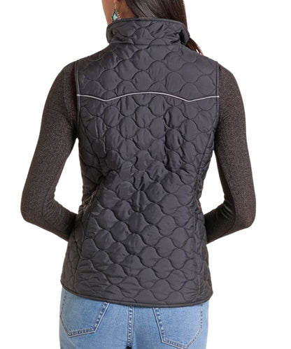 Back view of the women's black quilted reversible vest featuring the double pointed back yoke with grey piping, and the mock collar