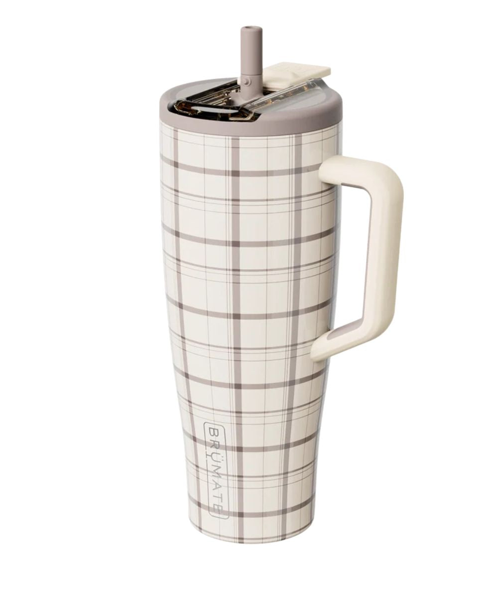 A tall insulated tumbler with a cream and brown plaid pattern, featuring a matching cream handle, a gray lid with a straw, and the brand name 'BURMAT' printed vertically near the bottom.