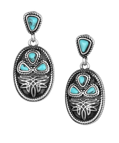 Front view of the women's antiqued silver dangle earrings featuring the boot stitch design and crafted turquoise stones
